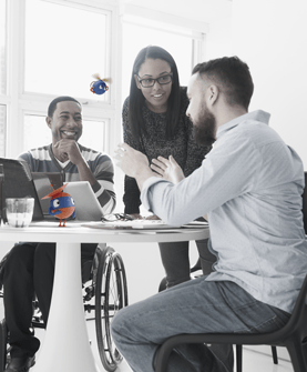 three people talking around a table